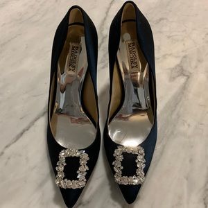 Badgley mischka crystal brooch crowns the pointed toe of a satin pump heel.